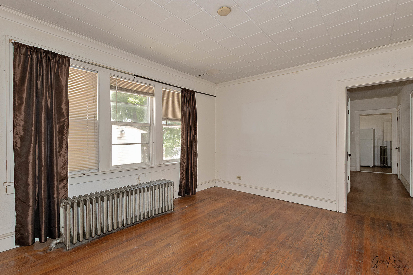 26308 West Rollins Road Ingleside, IL 60041 - Photo 5 of 26 a view of an empty room with wooden floor and a window