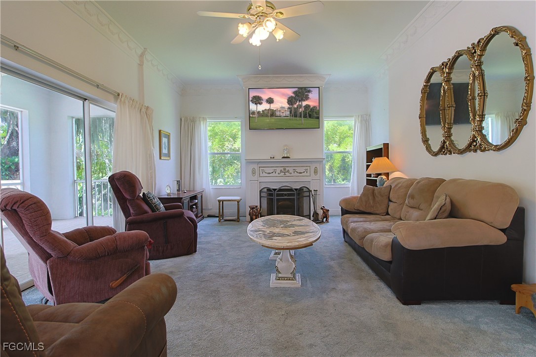 21810 Pearl Street Alva, FL 33920 - Photo 22 of 50 a living room with furniture a fireplace and a large mirror