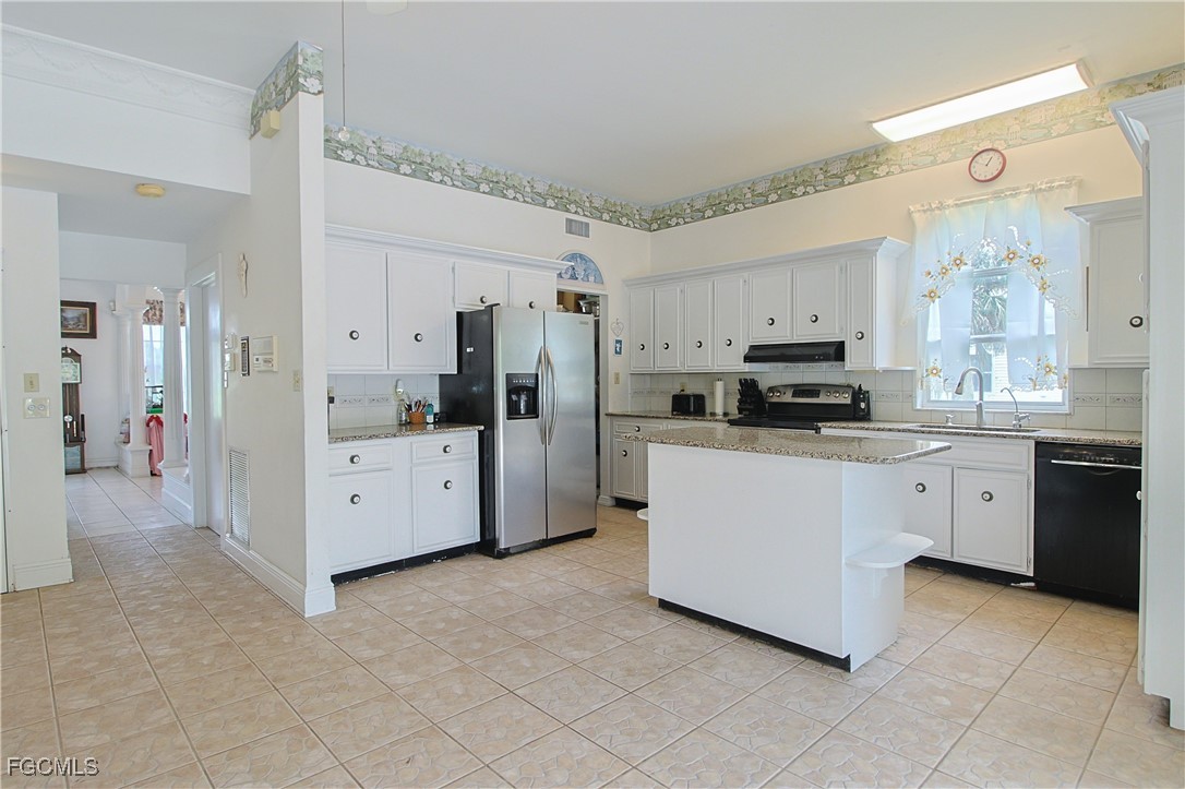 21810 Pearl Street Alva, FL 33920 - Photo 26 of 50 a kitchen with stainless steel appliances a refrigerator sink and cabinets
