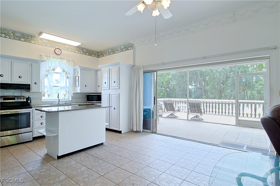 21810 Pearl Street Alva, FL 33920 - Photo 28 of 50 a large white kitchen with a large window appliances and sink