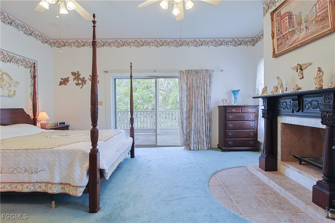 21810 Pearl Street Alva, FL 33920 - Photo 35 of 50 a bedroom with a bed and a fireplace