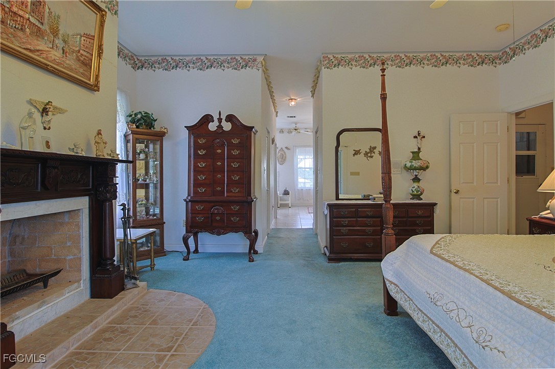 21810 Pearl Street Alva, FL 33920 - Photo 37 of 50 a spacious bedroom with a bed a dresser and storage