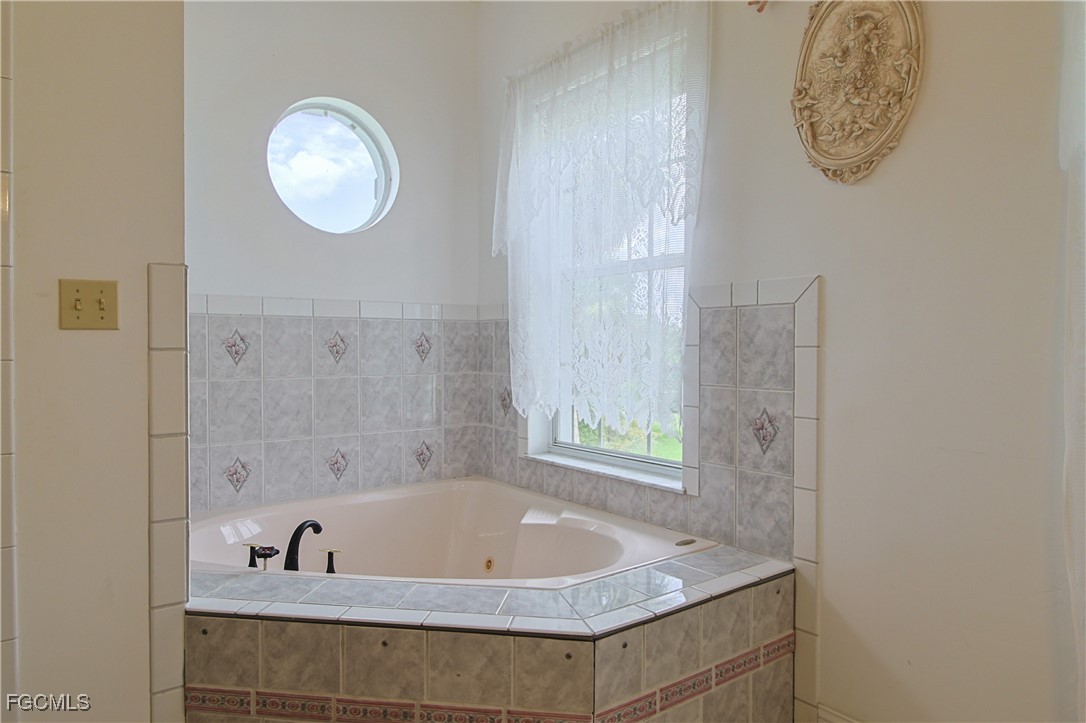 21810 Pearl Street Alva, FL 33920 - Photo 39 of 50 a bath tub sitting next to a small bathroom