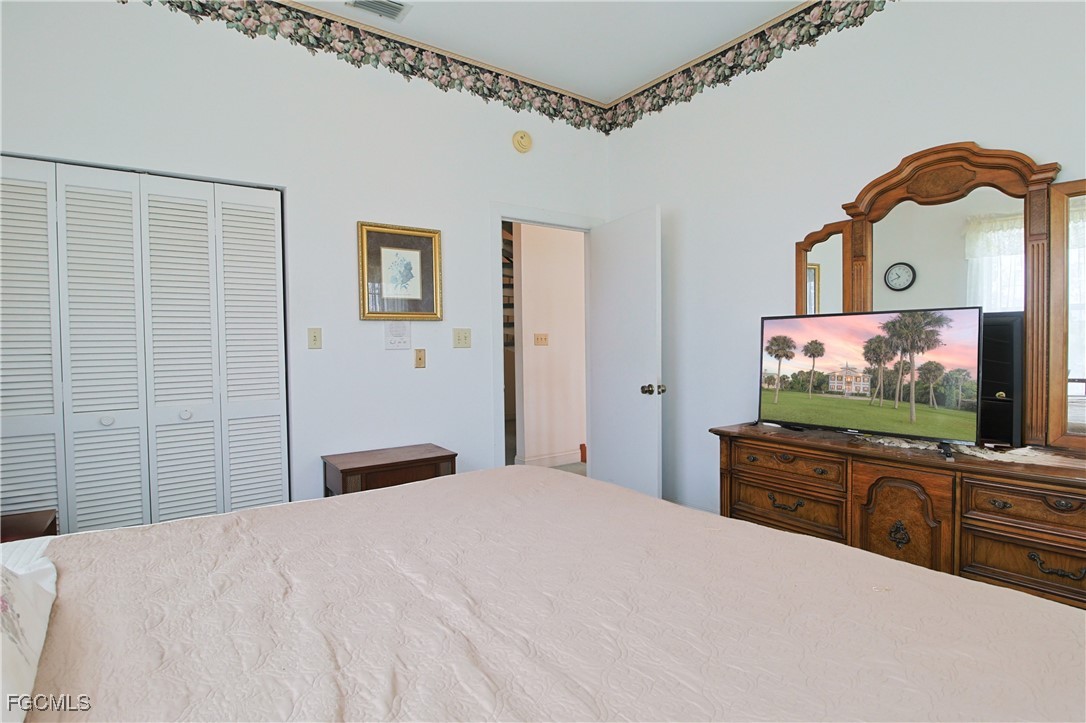 21810 Pearl Street Alva, FL 33920 - Photo 41 of 50 a bedroom with a bed and a flat screen tv