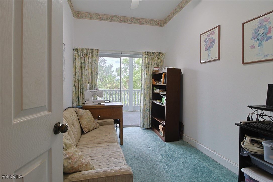 21810 Pearl Street Alva, FL 33920 - Photo 42 of 50 a living room with furniture and a floor to ceiling window