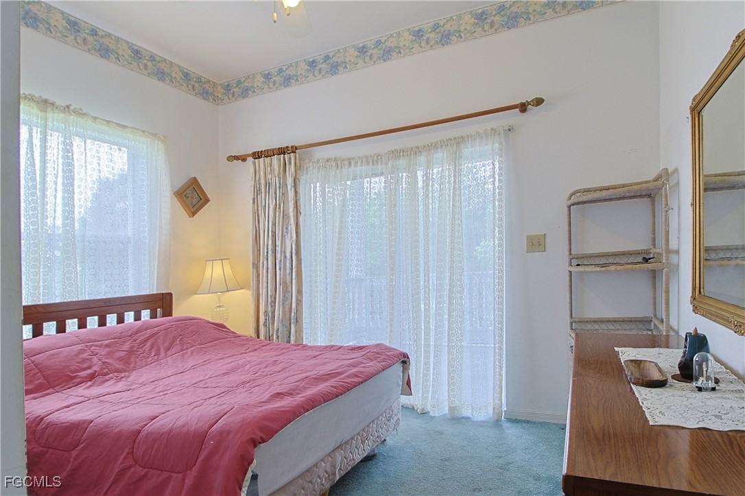 21810 Pearl Street Alva, FL 33920 - Photo 43 of 50 a bedroom with a bed and a cabinets