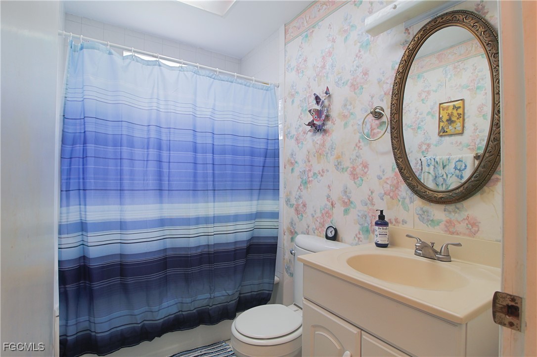 21810 Pearl Street Alva, FL 33920 - Photo 44 of 50 a bathroom with a toilet a sink and a shower