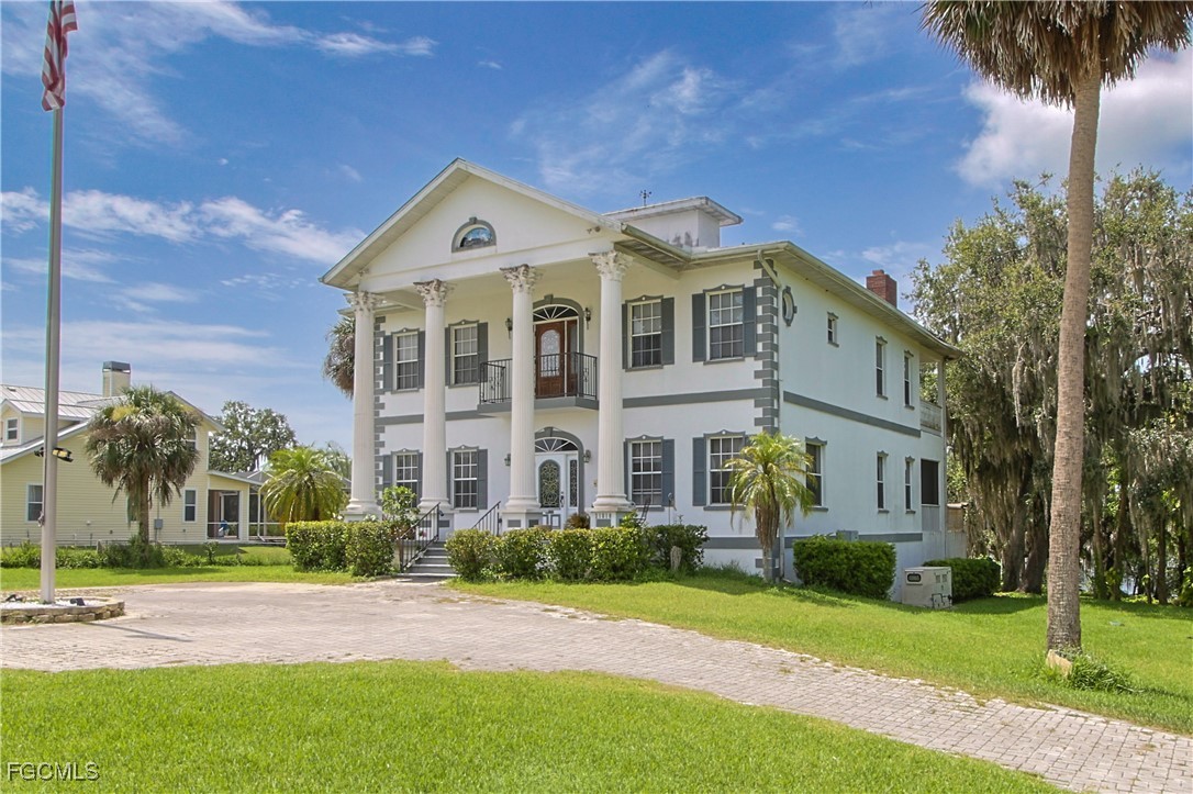 21810 Pearl Street Alva, FL 33920 - Photo 7 of 50 a front view of a house with a yard and potted plants