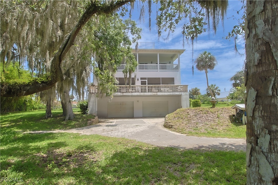 21810 Pearl Street Alva, FL 33920 - Photo 10 of 50 a backyard of a house with table and chairs