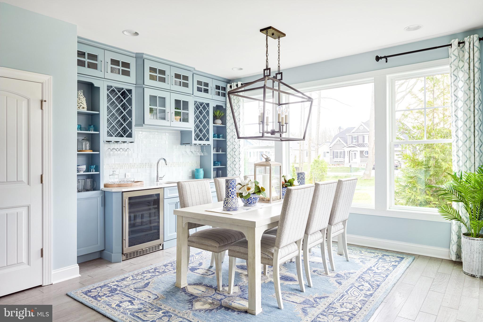 21811 Eastbridge Loop Lewes, DE 19958 - Photo 12 of 27 a dining room with furniture a chandelier and wooden floor