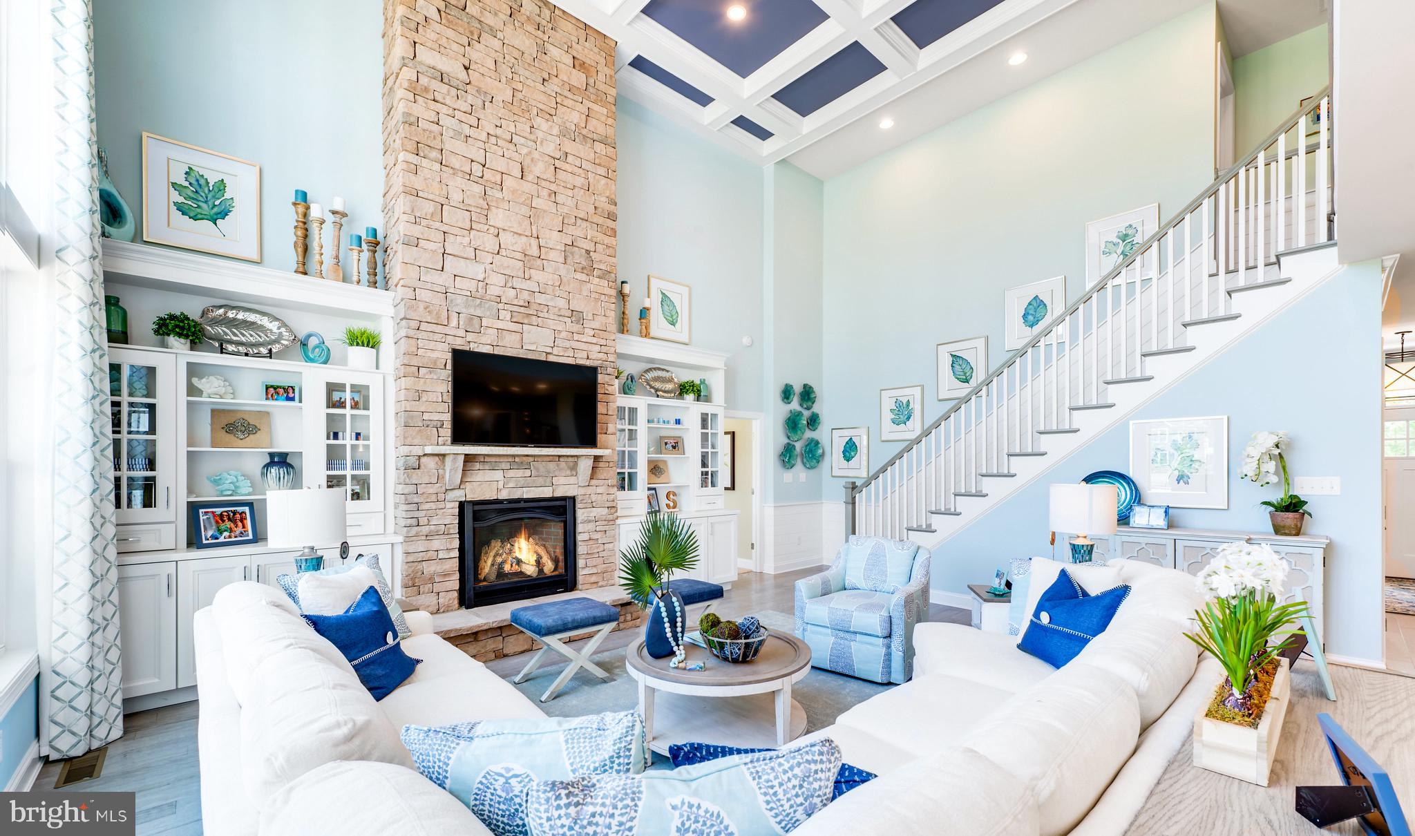 21811 Eastbridge Loop Lewes, DE 19958 - Photo 7 of 27 a living room with furniture fireplace and a potted plant