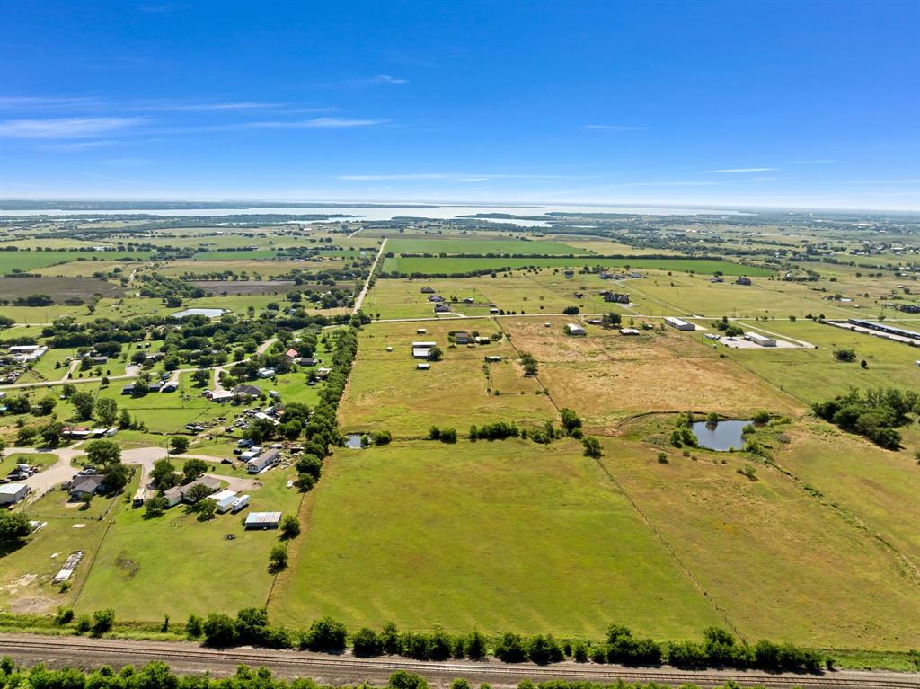 1795 Melton Road Sanger, TX 76266 - Photo 11 of 17 Expansive land parcels with mixed terrain and a prominent distant body of water