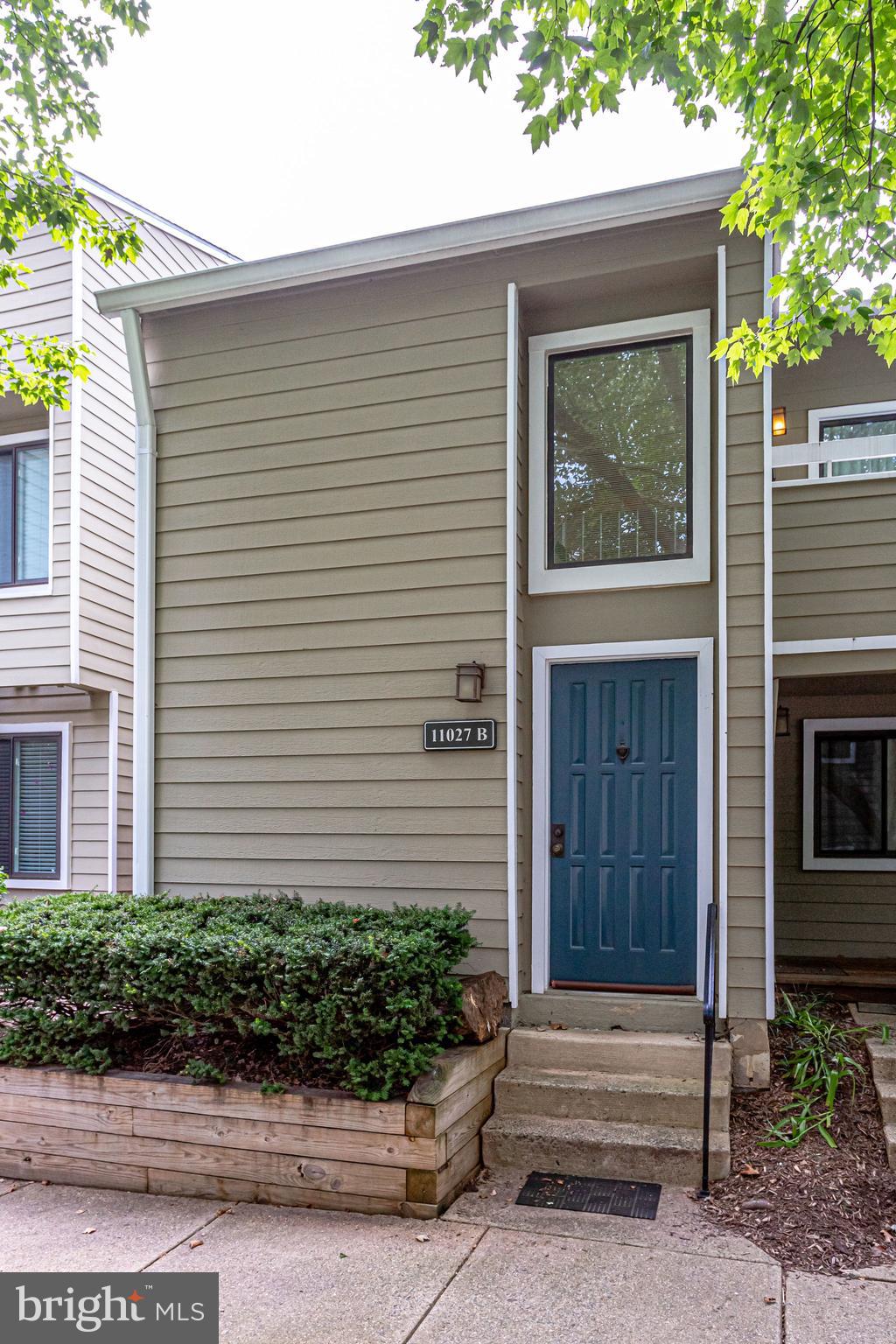 11027 Villaridge Court Reston, VA 20191 - Photo 4 of 28 a front view of a house with a yard