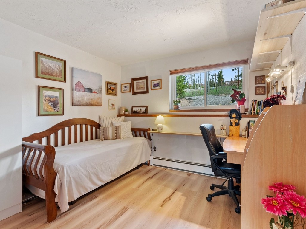 9825 Ryan Gulch Road, Unit B108 Silverthorne, CO 80498 - Photo 11 of 26 a bedroom with furniture and a window