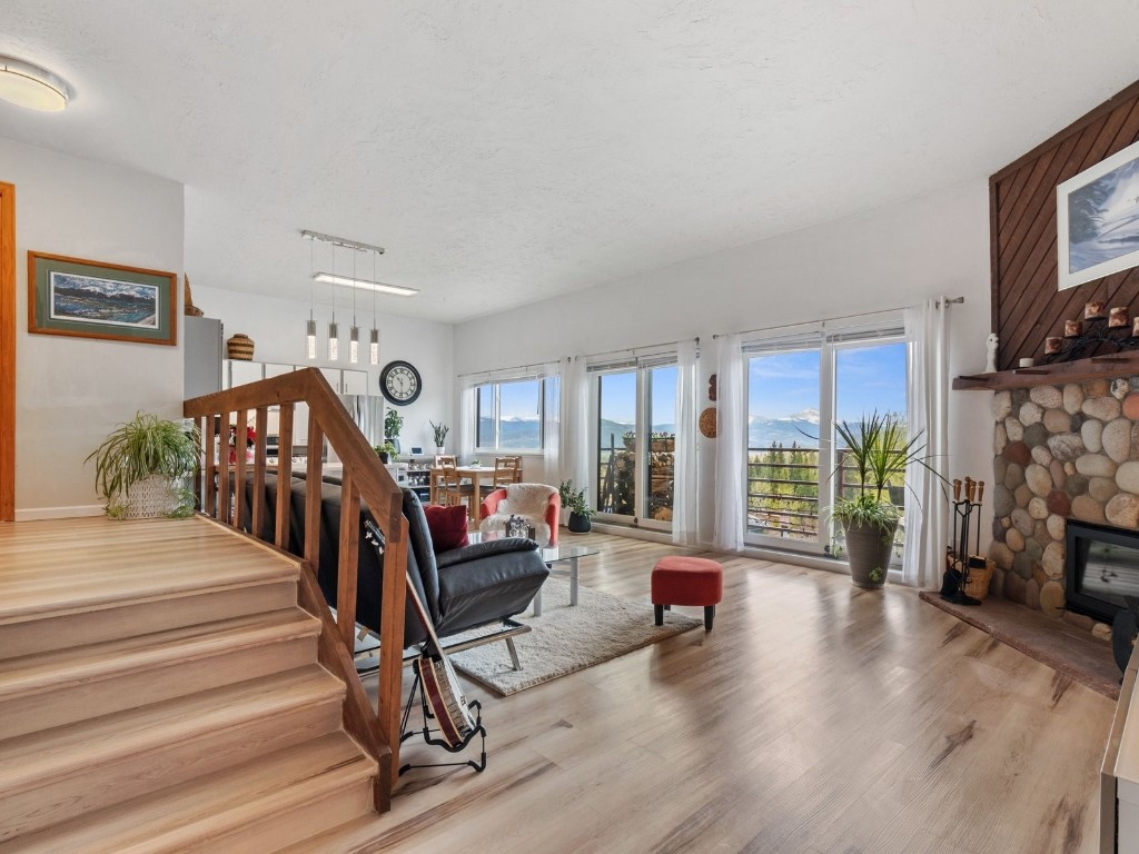 9825 Ryan Gulch Road, Unit B108 Silverthorne, CO 80498 - Photo 12 of 26 a living room with fireplace furniture and a wooden floor