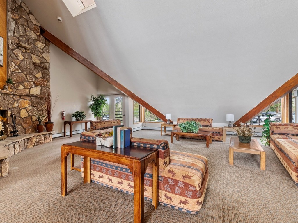 9825 Ryan Gulch Road, Unit B108 Silverthorne, CO 80498 - Photo 18 of 26 a living room with furniture and a wooden floor