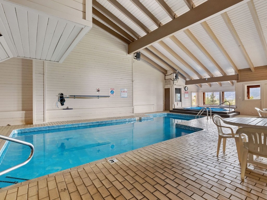 9825 Ryan Gulch Road, Unit B108 Silverthorne, CO 80498 - Photo 21 of 26 a kitchen with a sink and wooden cabinets