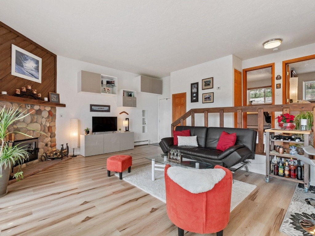 9825 Ryan Gulch Road, Unit B108 Silverthorne, CO 80498 - Photo 3 of 26 a living room with furniture and a wooden floor