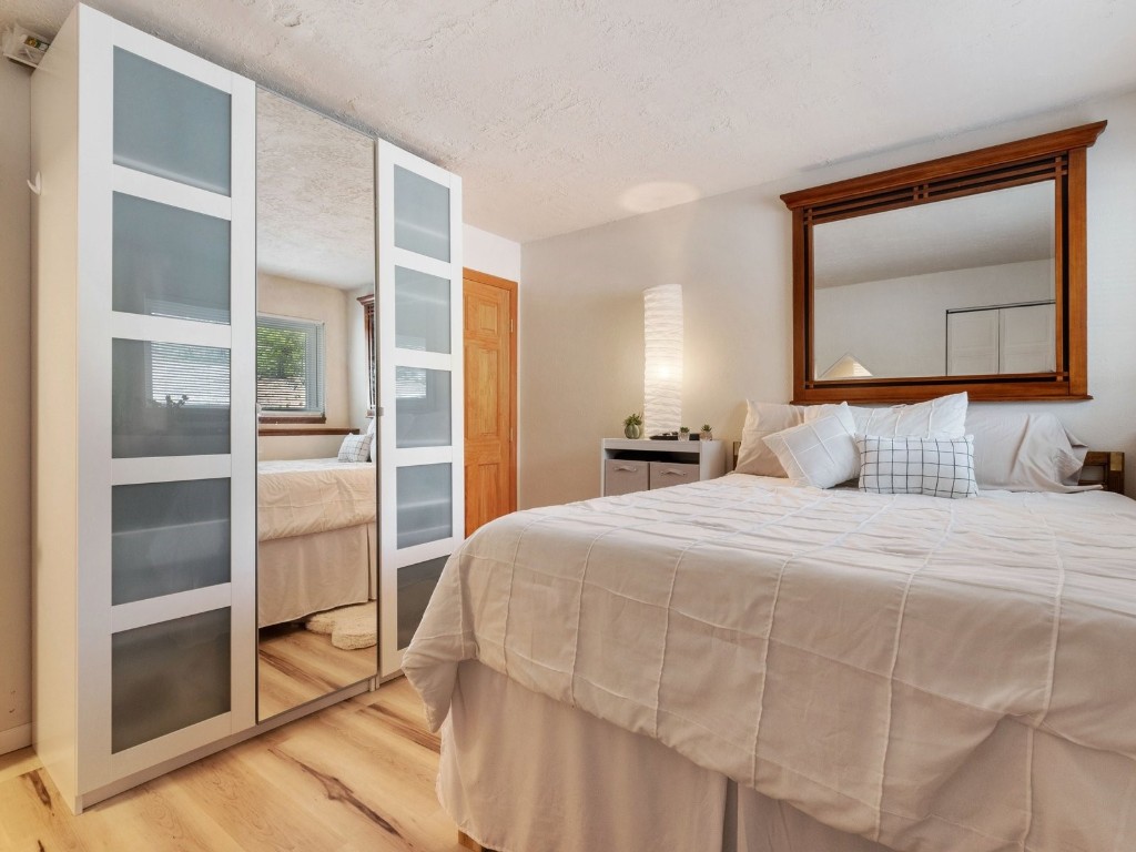 9825 Ryan Gulch Road, Unit B108 Silverthorne, CO 80498 - Photo 9 of 26 a bedroom with a bed and a painting on the wall