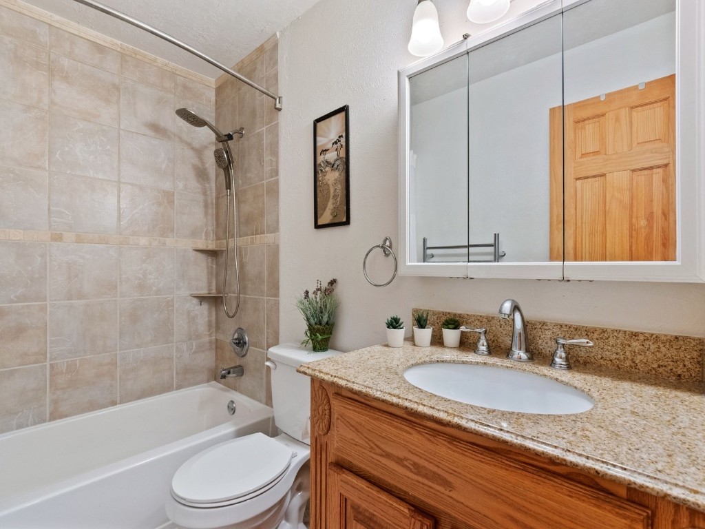 9825 Ryan Gulch Road, Unit B108 Silverthorne, CO 80498 - Photo 10 of 26 a bathroom with a granite countertop sink toilet tub and shower