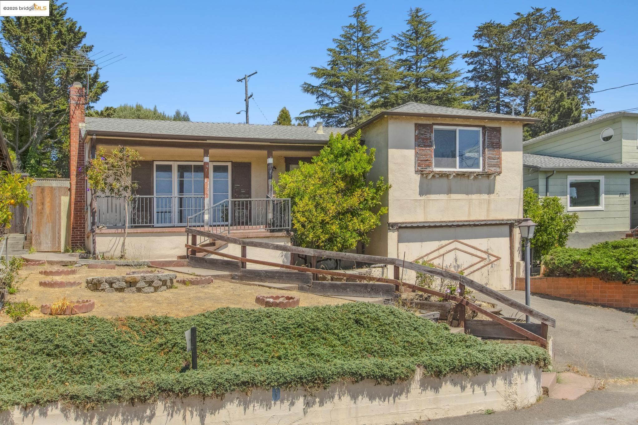 4751 Lincoln Avenue Oakland, CA 94602 - Photo 2 of 60 View of front of home with covered porch, a garage, driveway, a shingled roof, and stucco siding