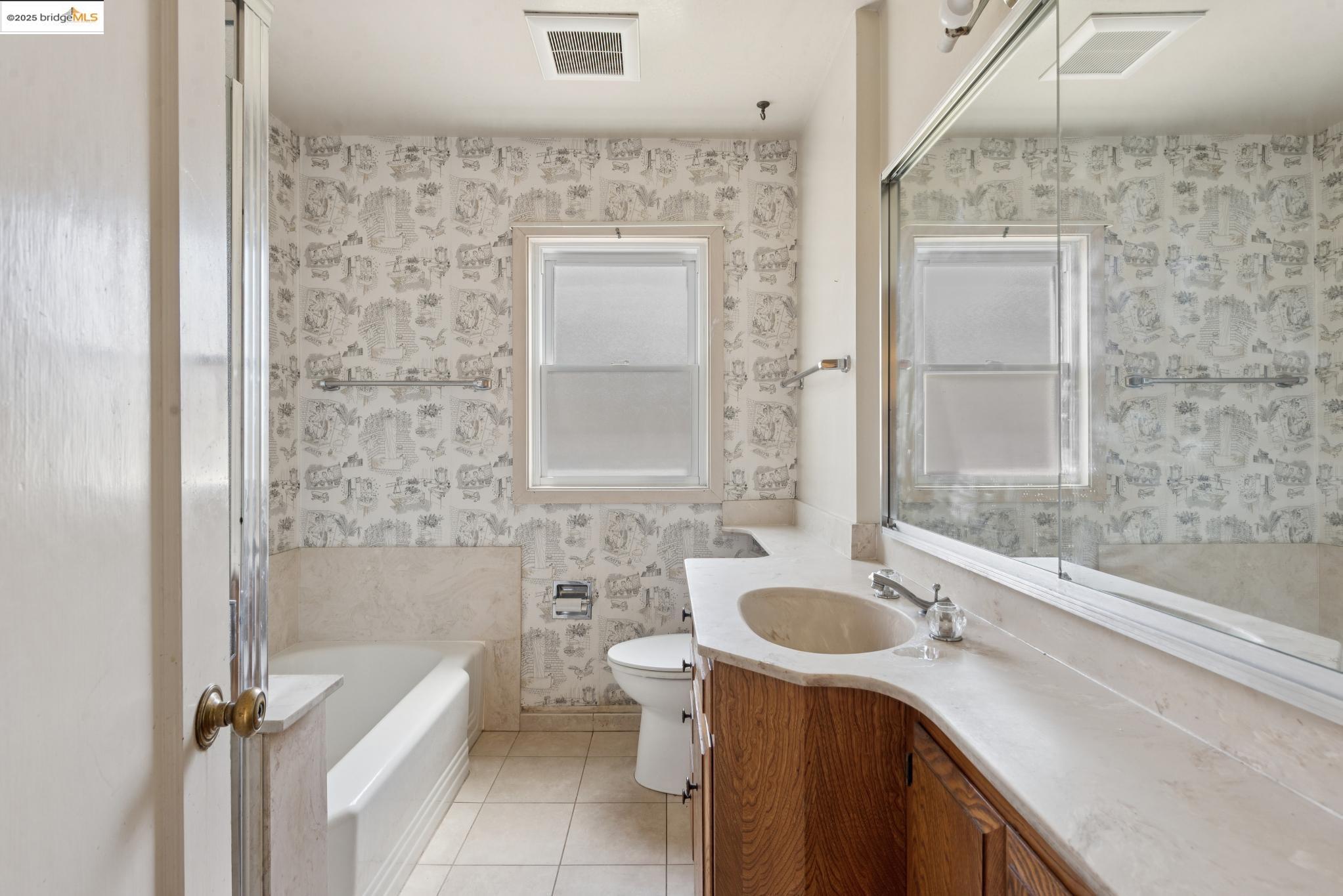 4751 Lincoln Avenue Oakland, CA 94602 - Photo 33 of 60 Full bathroom featuring light tile patterned flooring, vanity, a garden tub, and wallpapered walls