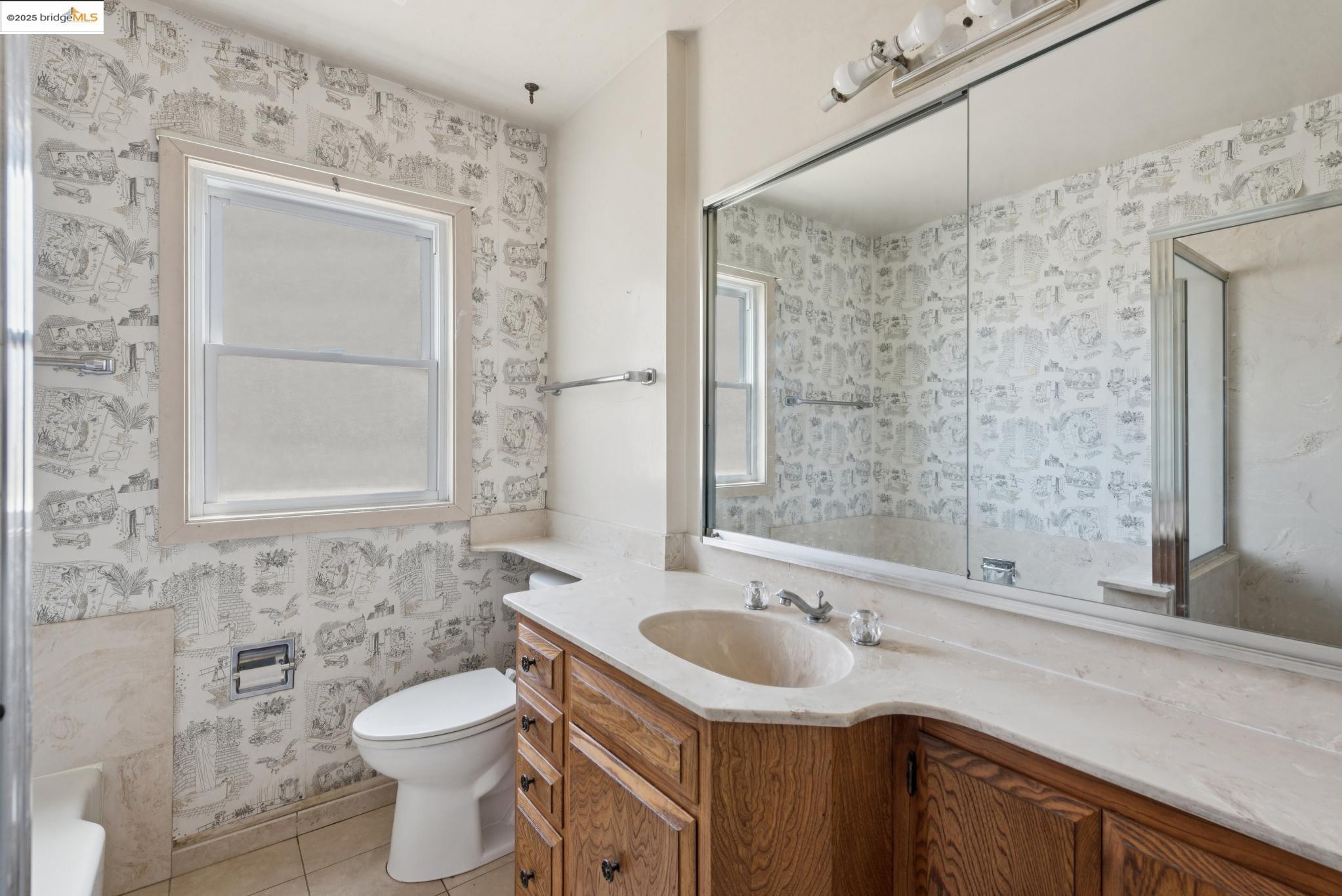 4751 Lincoln Avenue Oakland, CA 94602 - Photo 35 of 60 Full bath with wallpapered walls, vanity, and light tile patterned flooring