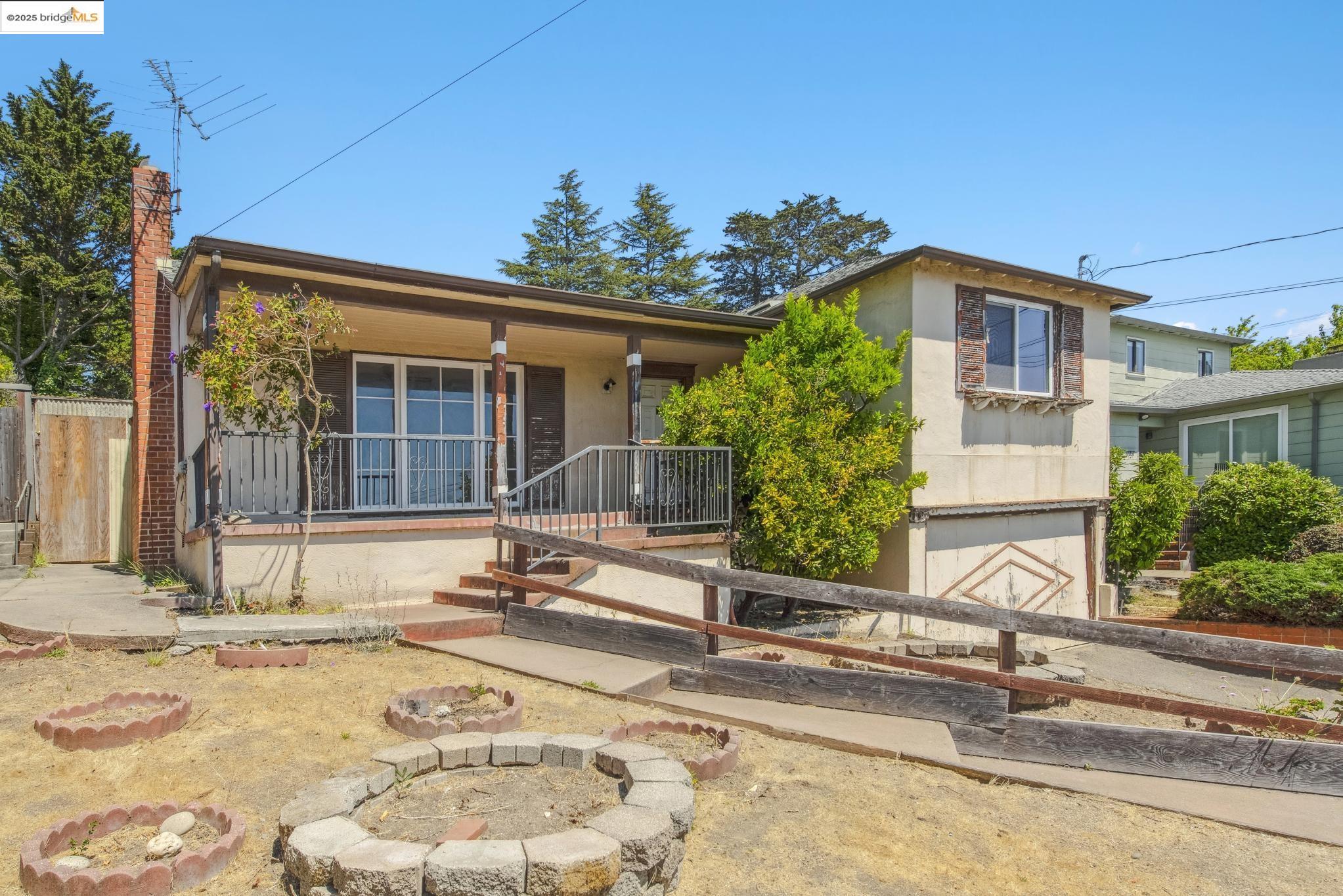 4751 Lincoln Avenue Oakland, CA 94602 - Photo 4 of 60 View of front facade with an attached garage, concrete driveway, a porch, and stucco siding