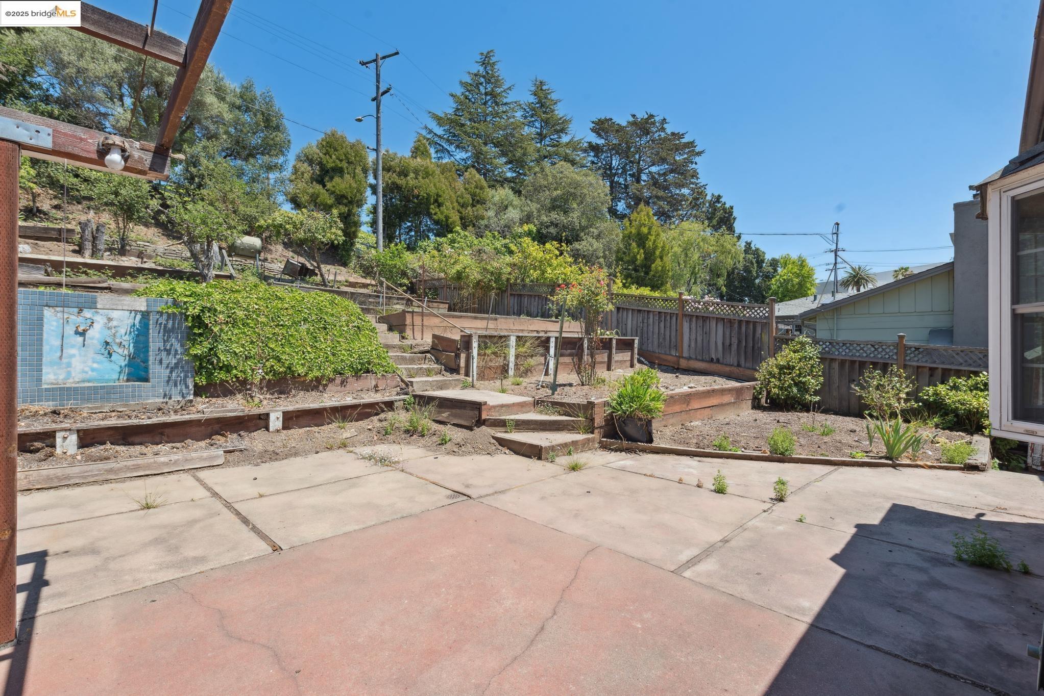 4751 Lincoln Avenue Oakland, CA 94602 - Photo 46 of 60 Fenced backyard with a vegetable garden and a patio area