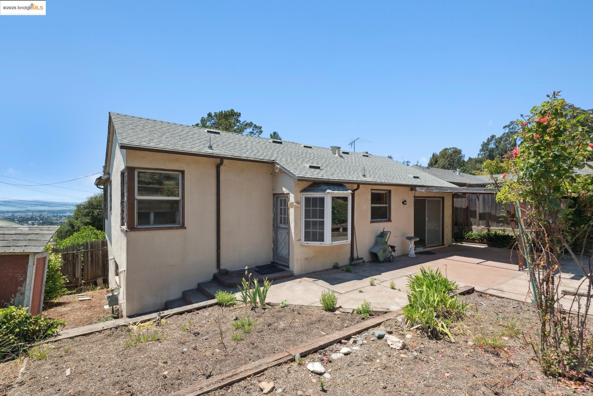 4751 Lincoln Avenue Oakland, CA 94602 - Photo 48 of 60 Rear view of house featuring roof with shingles, stucco siding, and a patio