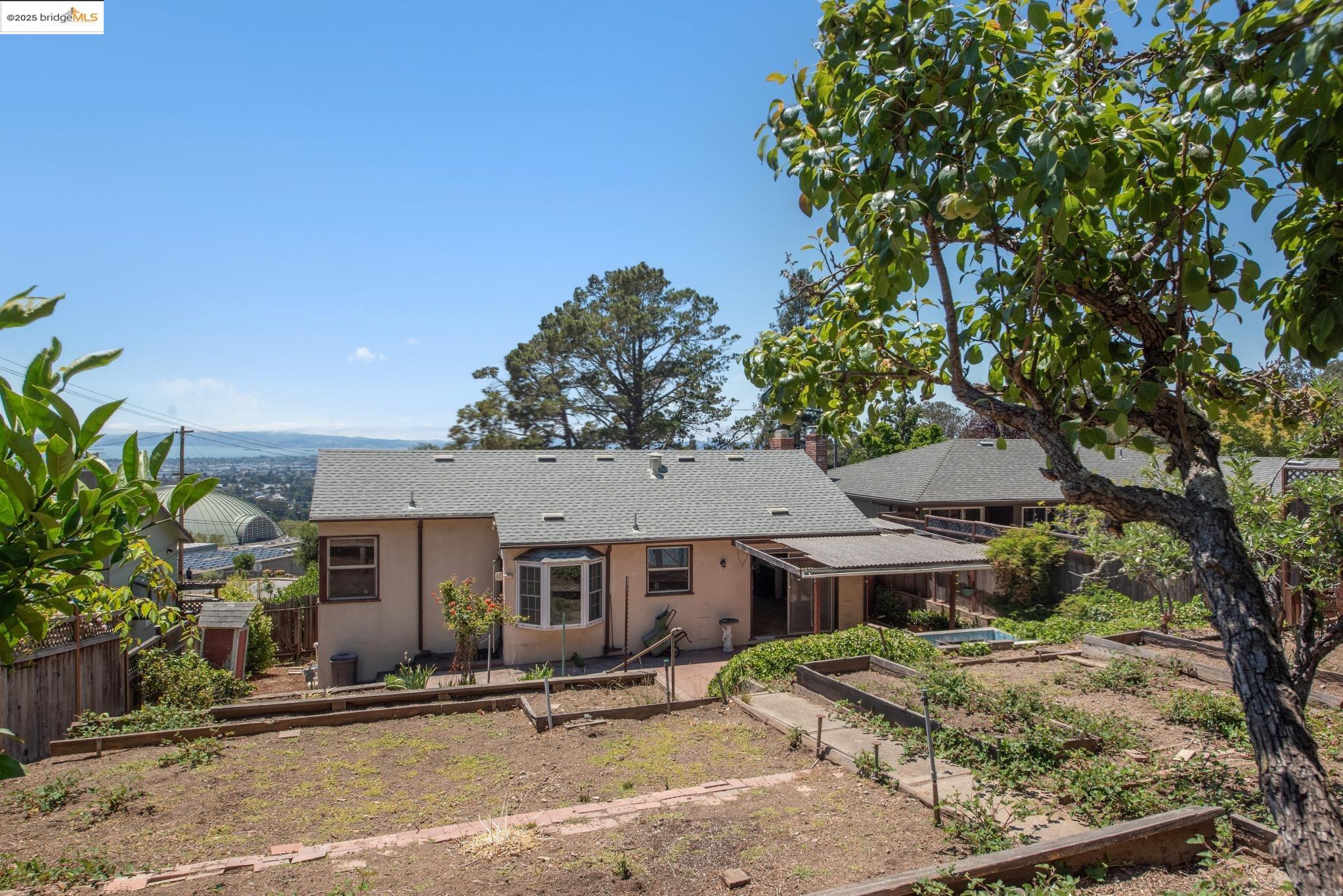 4751 Lincoln Avenue Oakland, CA 94602 - Photo 55 of 60 Rear view of property with a garden, roof with shingles, stucco siding, and a chimney
