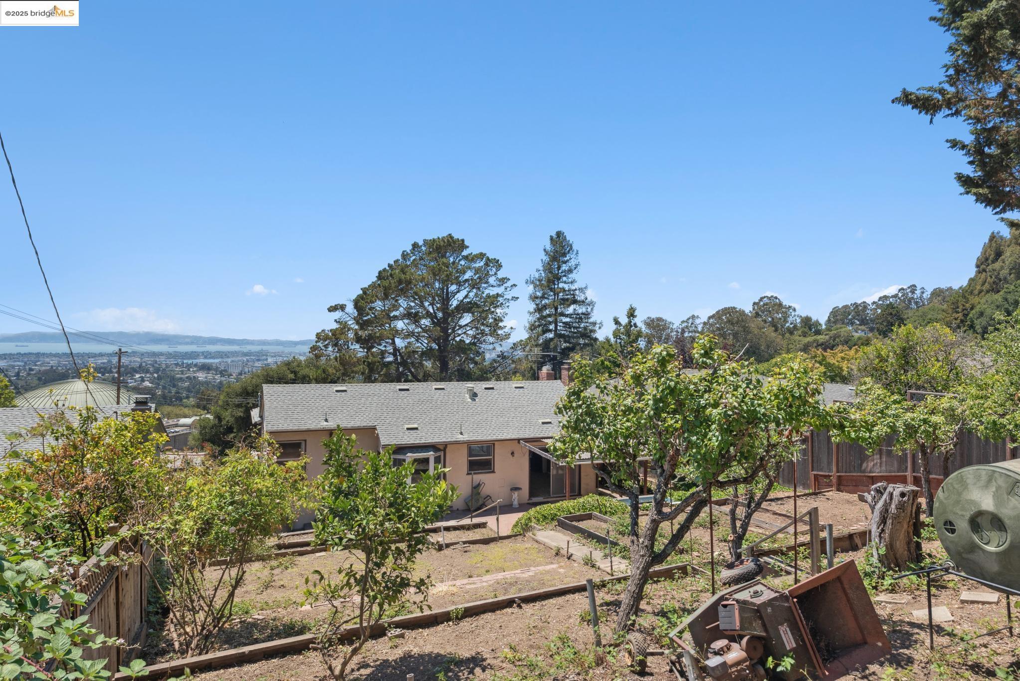 4751 Lincoln Avenue Oakland, CA 94602 - Photo 57 of 60 Rear view of property featuring a vegetable garden and a chimney