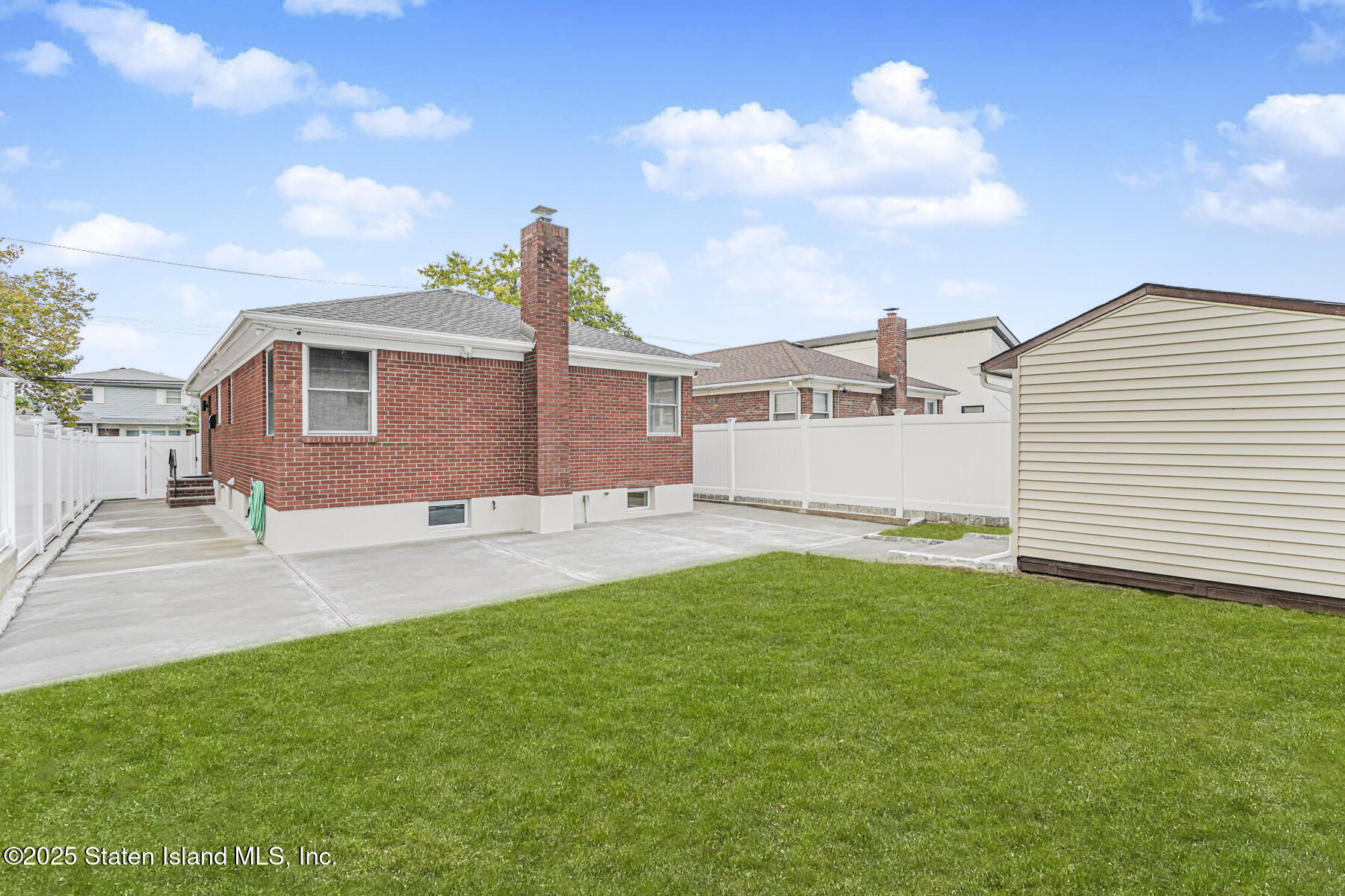 236 Amber Street Staten Island, NY 10306 - Photo 19 of 22 a front view of a house with a yard and garage