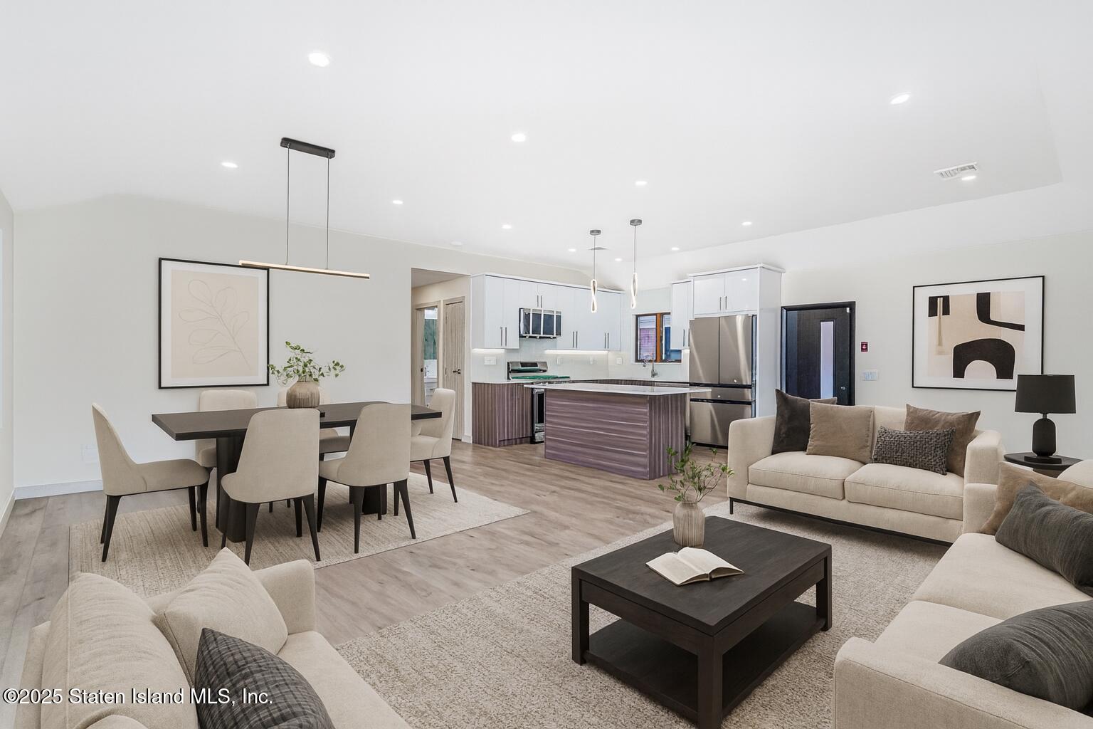 236 Amber Street Staten Island, NY 10306 - Photo 3 of 22 a living room with furniture a wooden floor and kitchen view