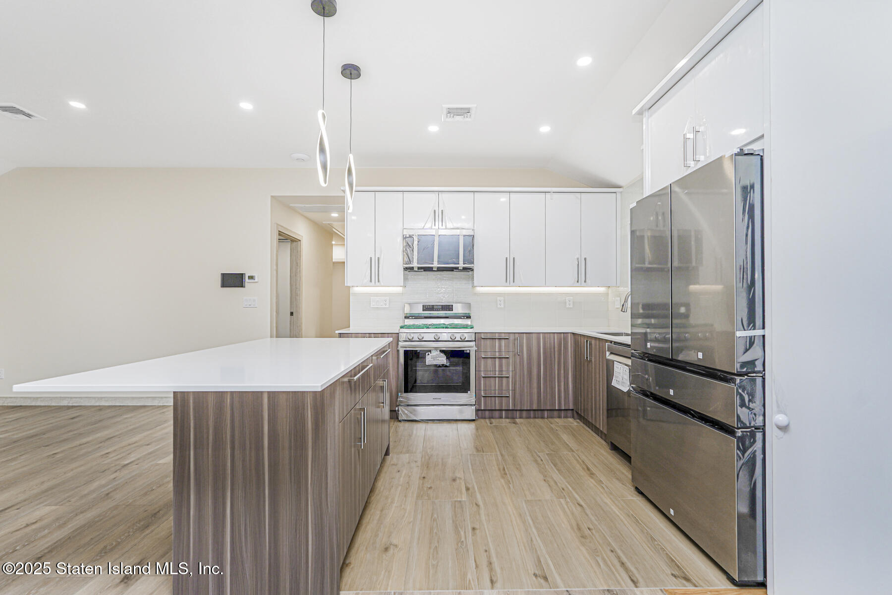 236 Amber Street Staten Island, NY 10306 - Photo 7 of 22 a kitchen with kitchen island a counter top space a stove and cabinets