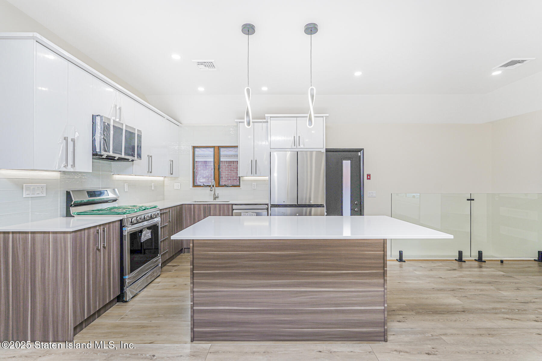 236 Amber Street Staten Island, NY 10306 - Photo 8 of 22 a large kitchen with stainless steel appliances kitchen island a large island in the center