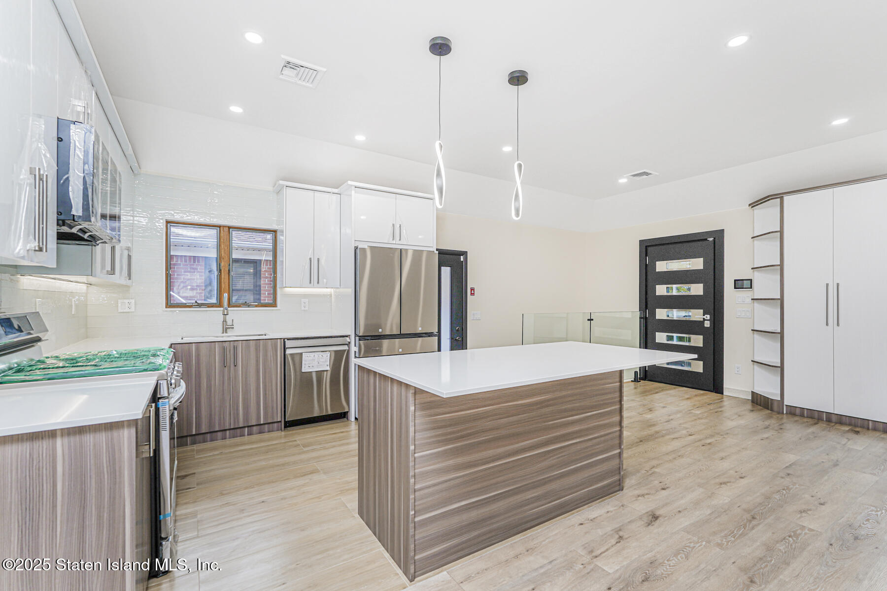 236 Amber Street Staten Island, NY 10306 - Photo 9 of 22 a kitchen with a refrigerator a sink and wooden floor