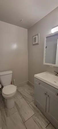 a view of an empty room with a ceiling fan