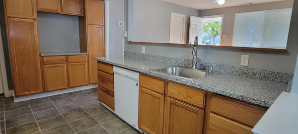 a kitchen with stainless steel appliances granite countertop a sink and a granite counter tops