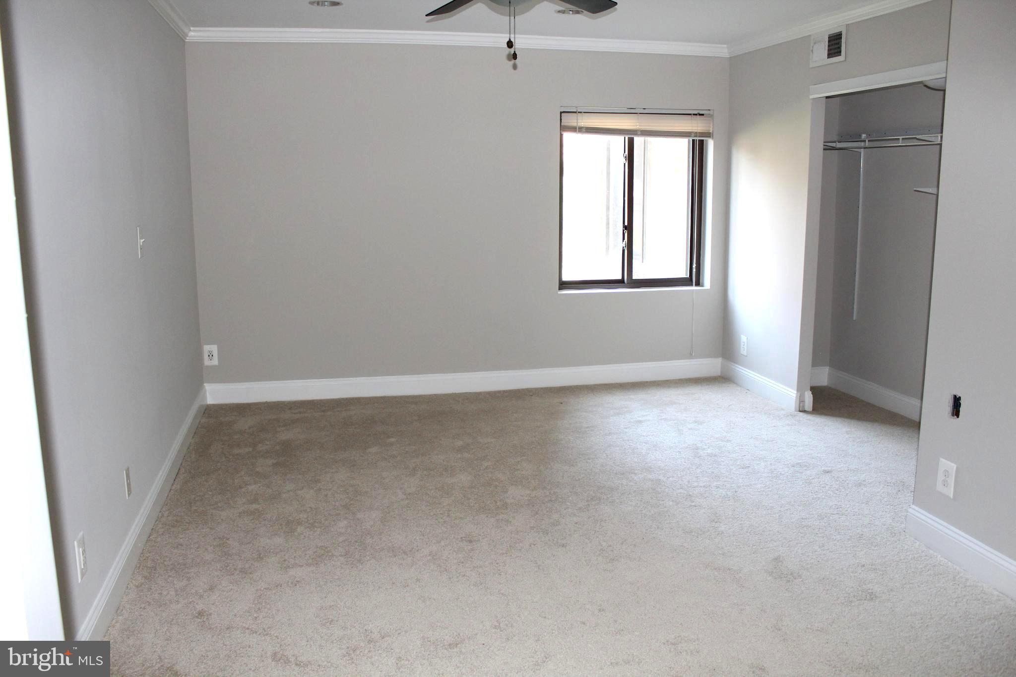 11204 Cherry Hill Road, Unit T2 Beltsville, MD 20705 - Photo 17 of 37 an empty room with windows and closet