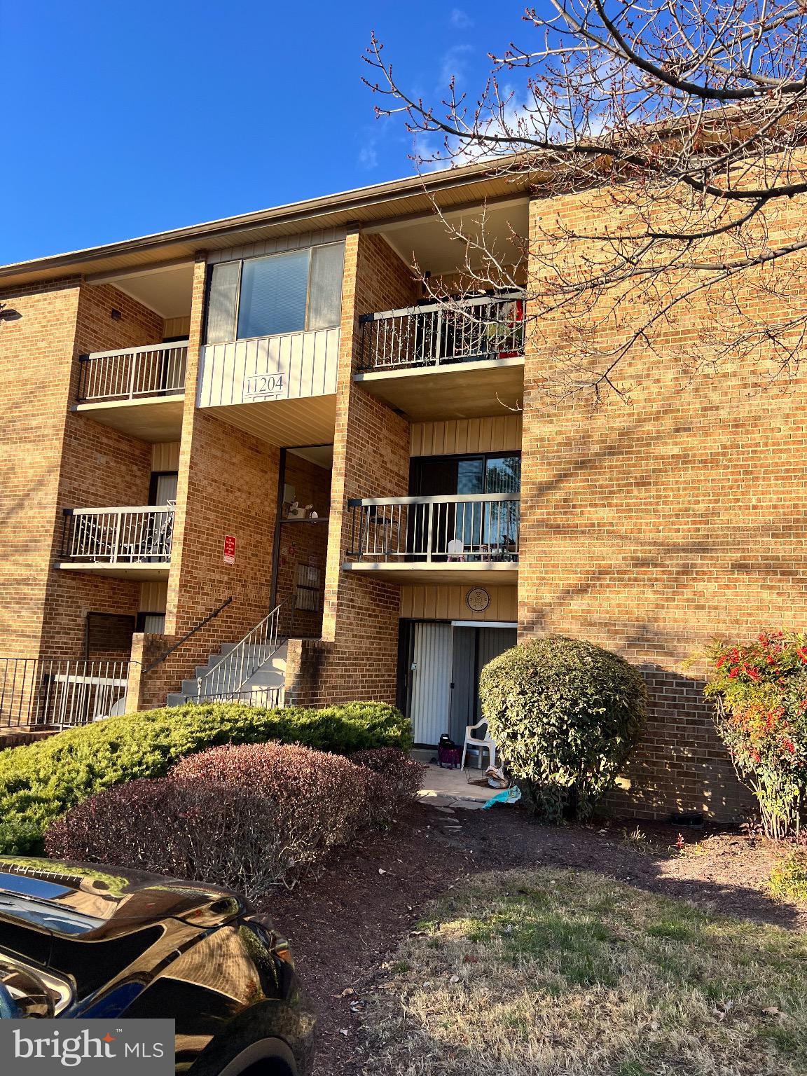 11204 Cherry Hill Road, Unit T2 Beltsville, MD 20705 - Photo 2 of 2 a front view of a house with a yard