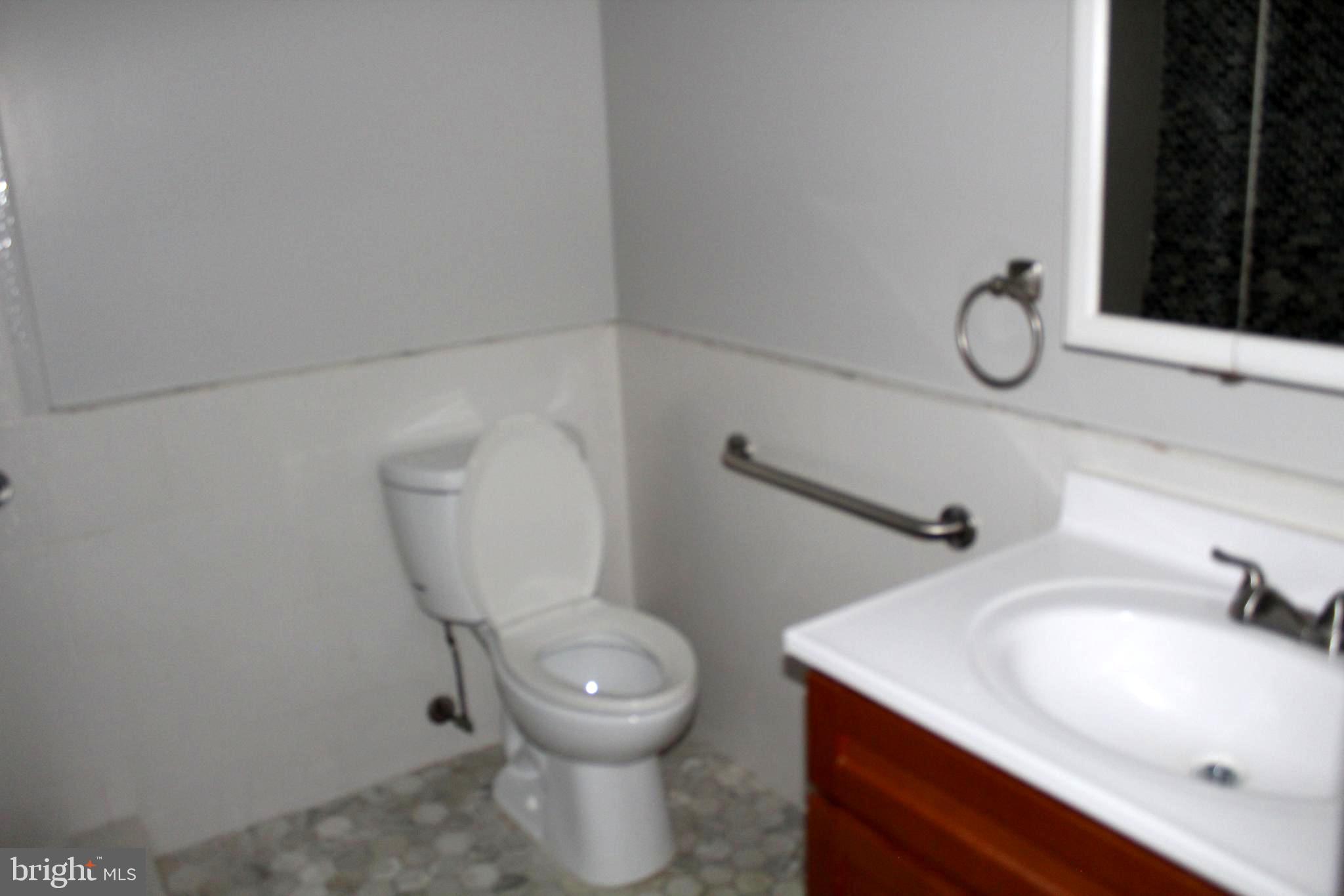 11204 Cherry Hill Road, Unit T2 Beltsville, MD 20705 - Photo 21 of 37 a bathroom with a sink toilet and a mirror