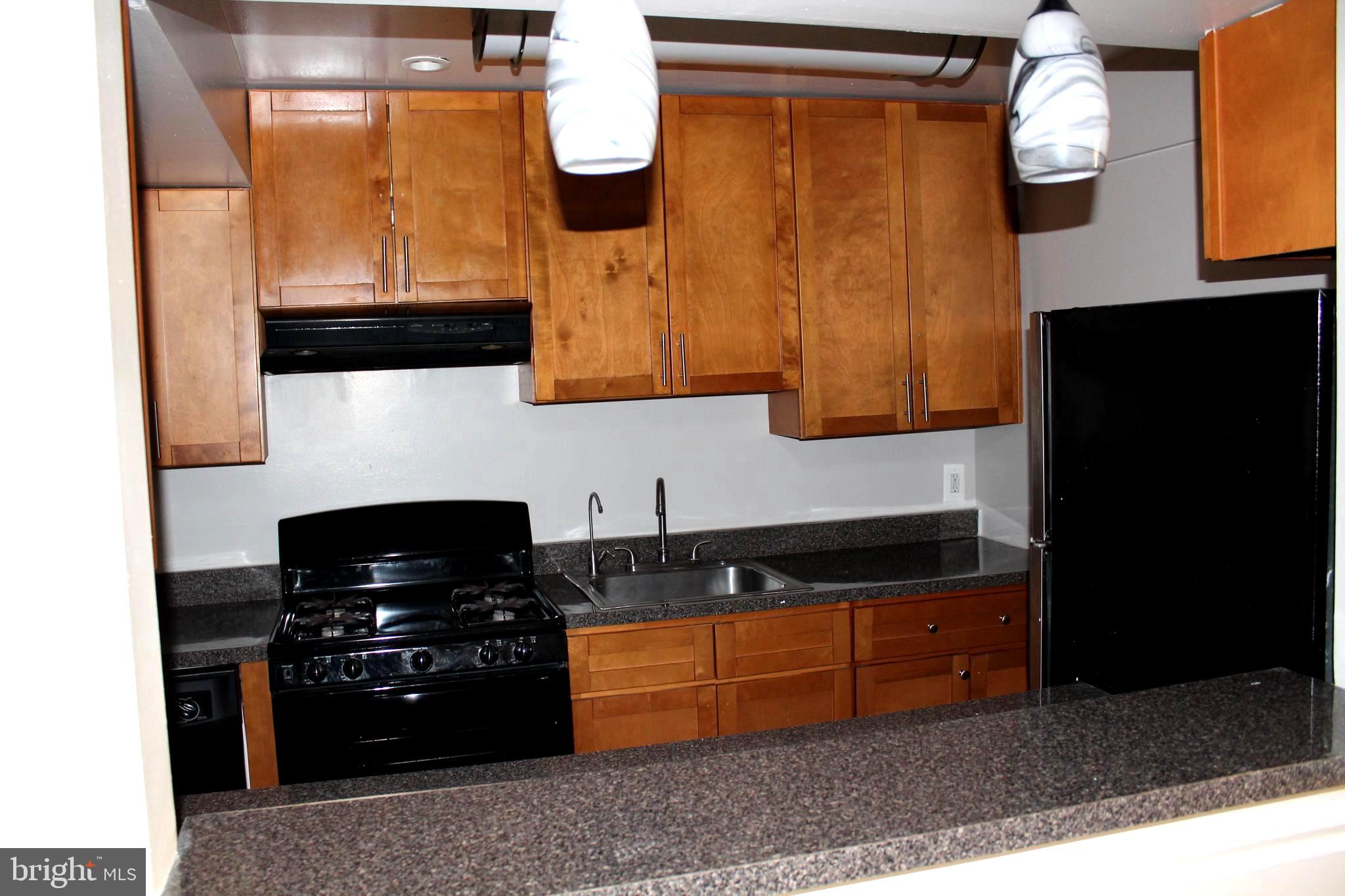 11204 Cherry Hill Road, Unit T2 Beltsville, MD 20705 - Photo 26 of 37 a kitchen with stainless steel appliances granite countertop a stove and a refrigerator
