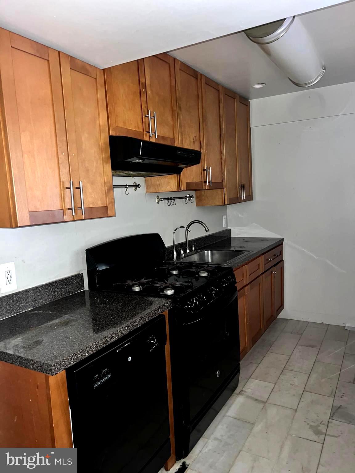 11204 Cherry Hill Road, Unit T2 Beltsville, MD 20705 - Photo 30 of 37 a kitchen with a sink a stove and cabinets
