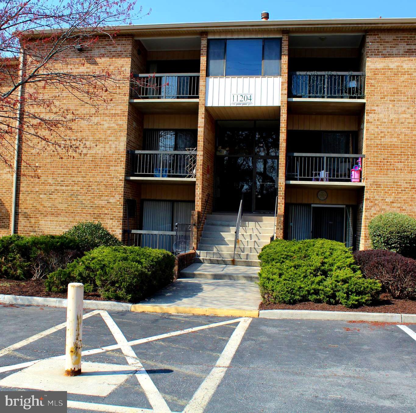 11204 Cherry Hill Road, Unit T2 Beltsville, MD 20705 - Photo 36 of 37 a front view of a building with plants