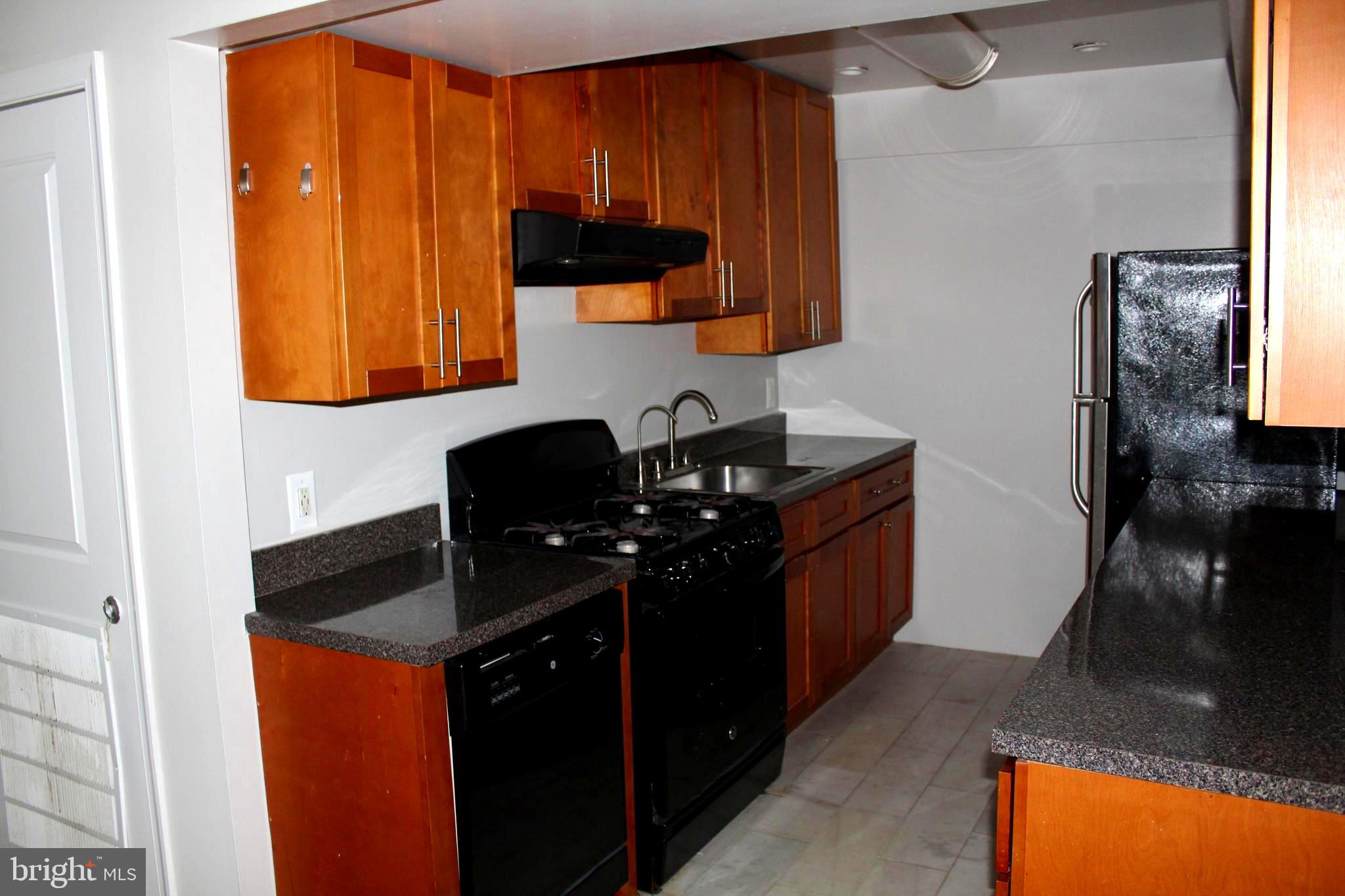 11204 Cherry Hill Road, Unit T2 Beltsville, MD 20705 - Photo 9 of 37 a kitchen with a sink and a stove top oven