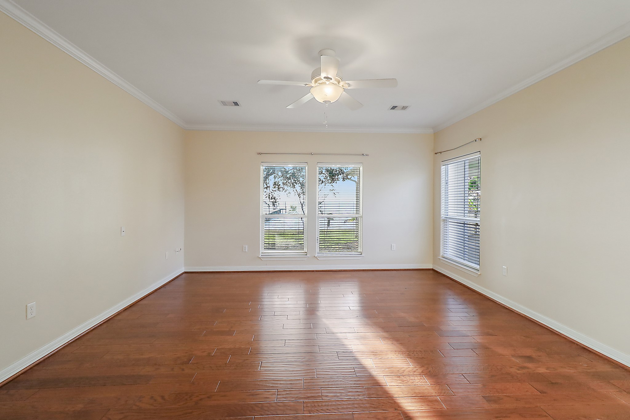 4521 West Bayshore Road, Unit A Anahuac, TX 77514 - Photo 11 of 34 a view of an empty room with wooden floor and a window