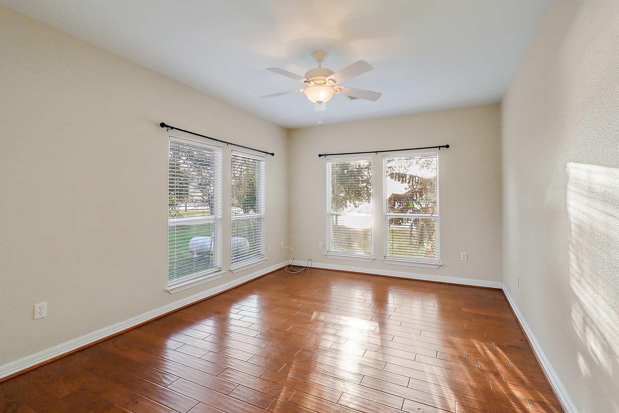 4521 West Bayshore Road, Unit A Anahuac, TX 77514 - Photo 16 of 34 a view of an empty room with wooden floor and a window