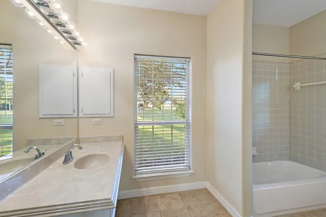 a view of an empty room with exposed radiator and fireplace