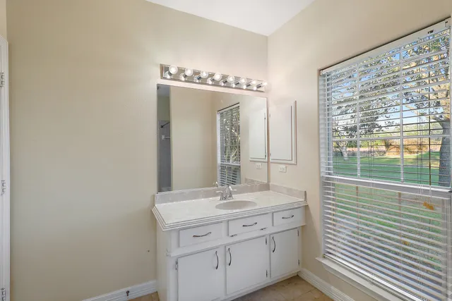 a view of a room with wooden floor fireplace and windows